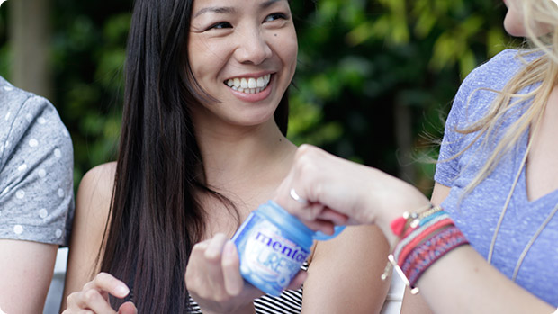 Image showing girl sharing Mentos with friends 